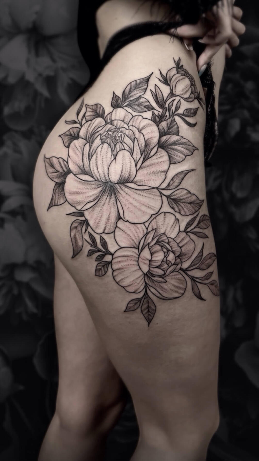Untitled Igor Vtoroff | Elegant floral thigh tattoo with peonies in graphic whipshading style. Torrevieja, Alicante, Spain.