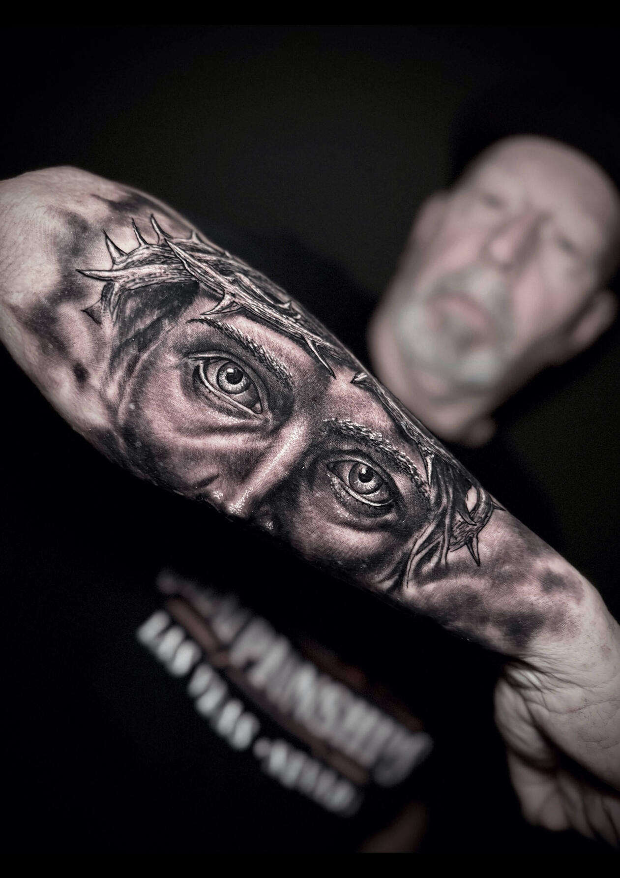 Untitled Realistic Jesus Christ eyes with crown of thorns tattoo by Igor Vtoroff. Premium religious black and grey realism in Torrevieja, Alicante, Spain.